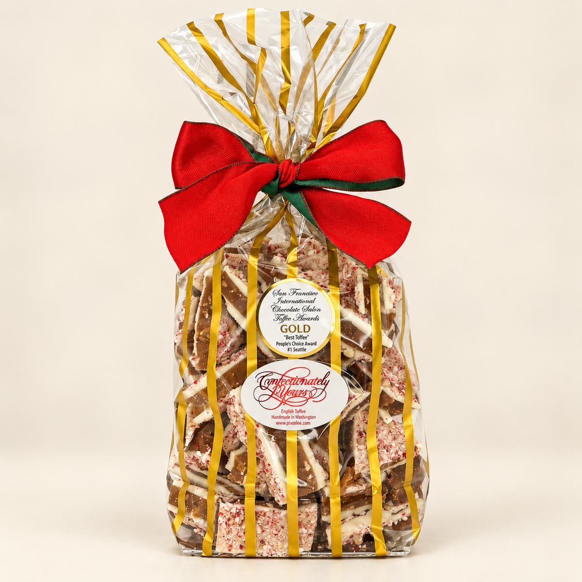 Confectionately Yours 1.5-pound white chocolate peppermint English toffee in a festive holiday gift bag with red bow