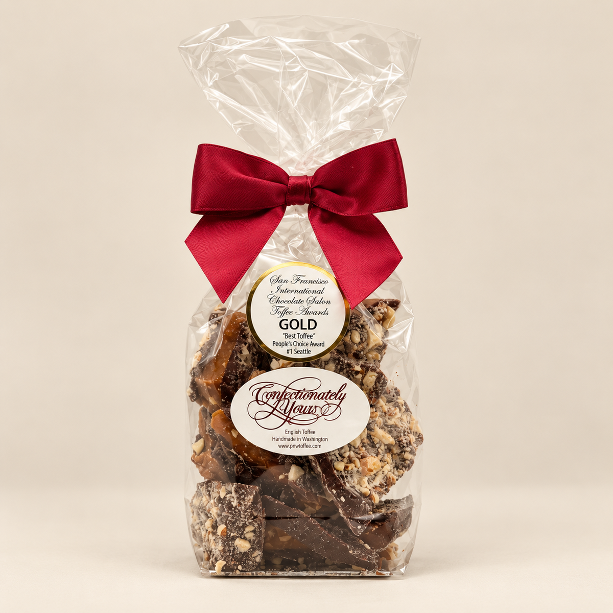 Half-pound Confectionately Yours dark chocolate almond English toffee in a clear gift bag with burgundy bow