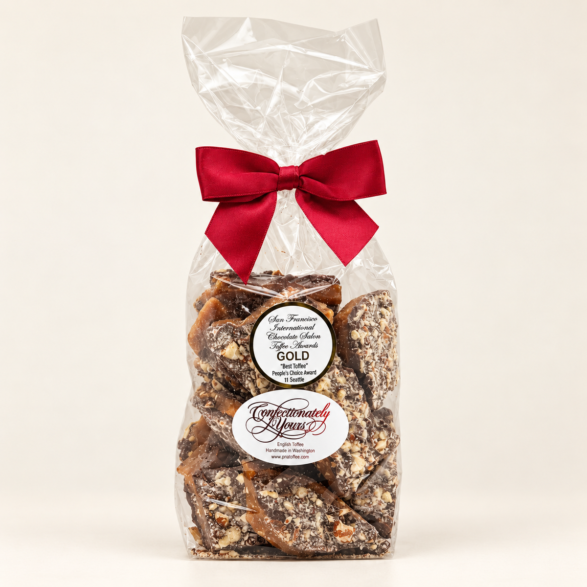 One-pound Confectionately Yours dark chocolate almond English toffee in a clear gift bag with burgundy bow