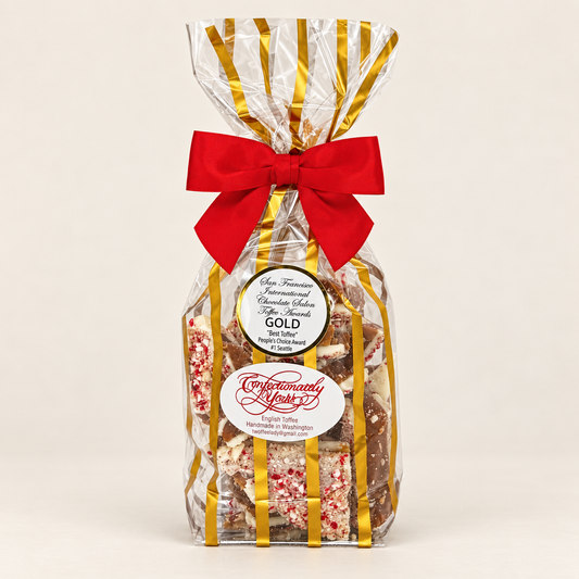 Confectionately Yours half-pound white chocolate peppermint English toffee in a festive holiday gift bag with red bow